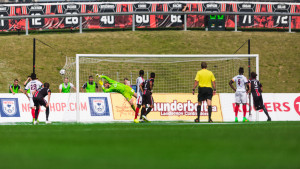 Ottawa's Heinemann sends a ball past Kristian Nicht (Photo by Richard A. Whittaker/Ottawa Fury)