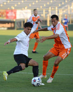Kupono Low defends against San Antonio's Cesar Elizondo in 2015 (Photo:Rob Kinnan/Carolina RailHawks)
