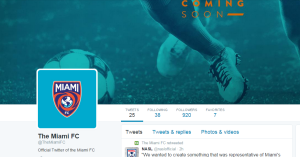 The 'Coming Soon' header image used by Miami FC on Twitter which displays orange text on a teal tinted background.